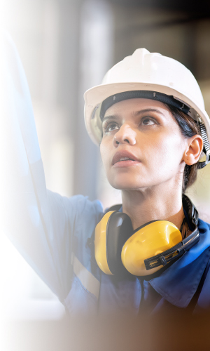 Women in industrial setting wearing PPE